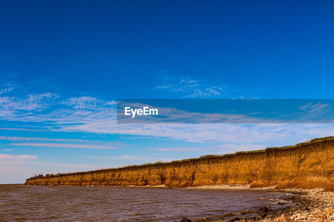 Scenic view of sea against blue sky