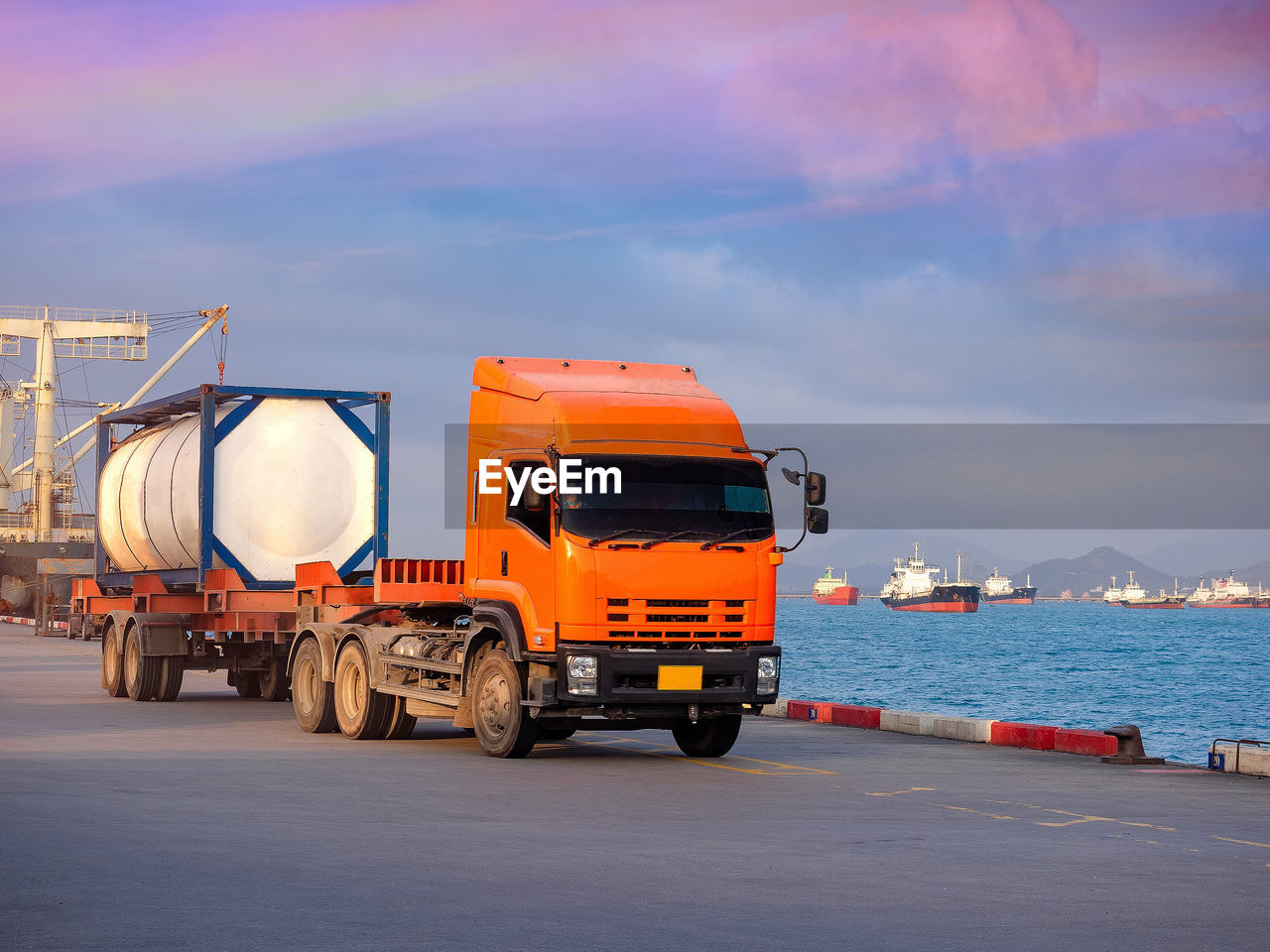 Truck parked by sea against sky