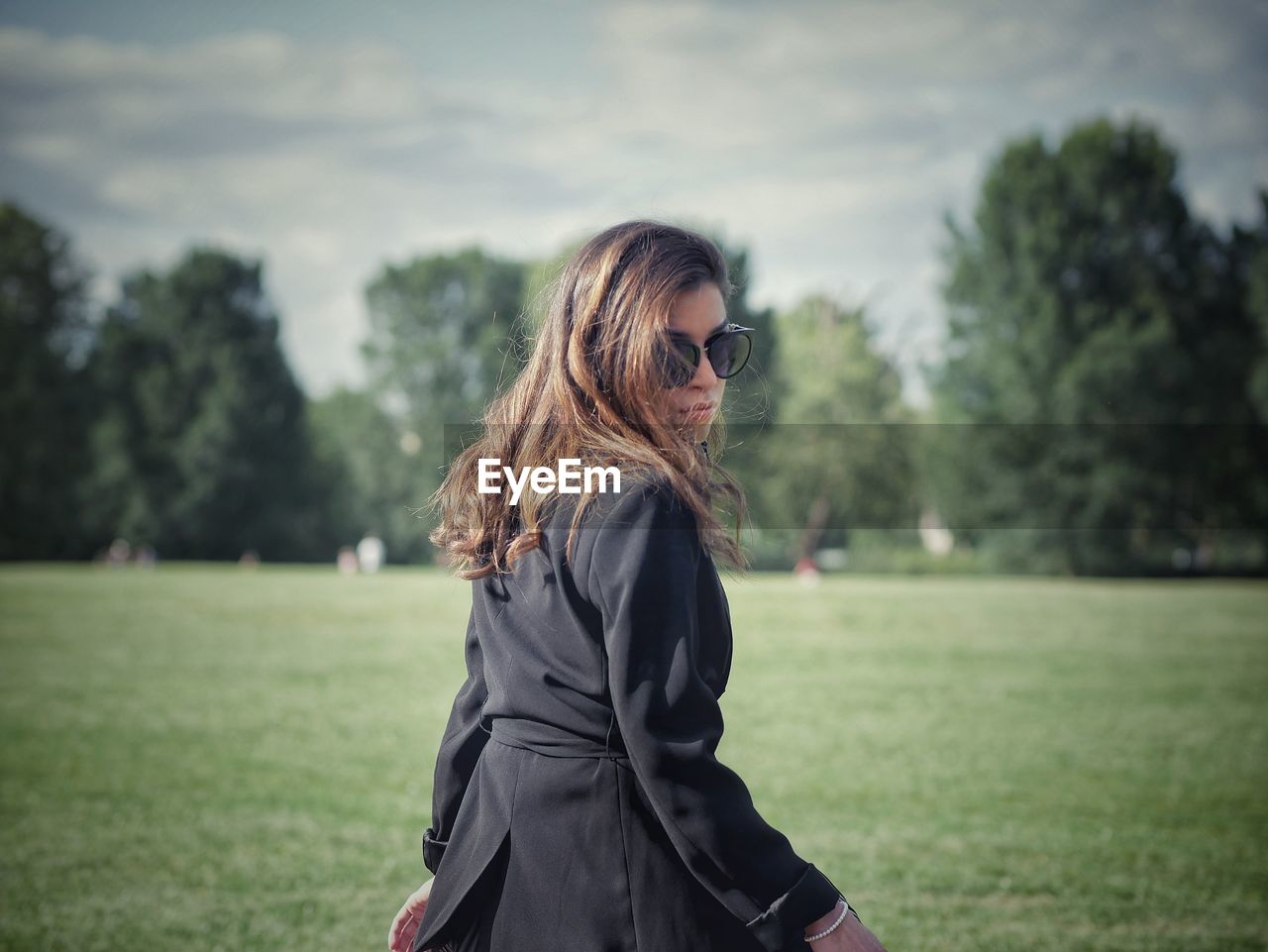 WOMAN LOOKING AT TREE