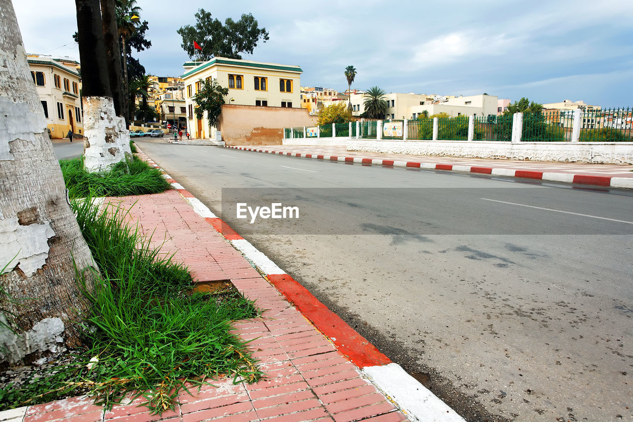 ROAD BY BUILT STRUCTURE AGAINST SKY