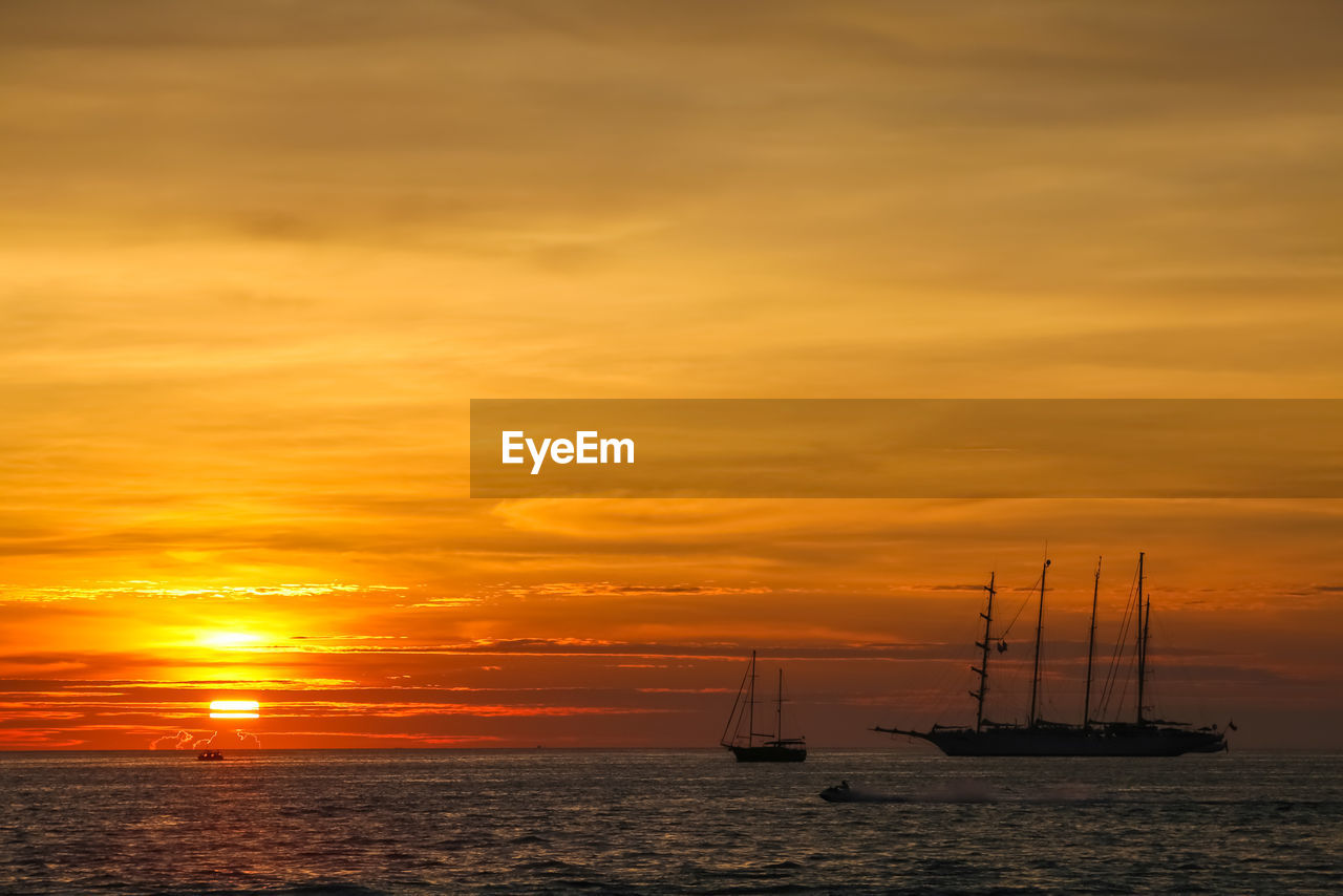 sky, sunset, sea, water, nautical vessel, transportation, cloud, mode of transportation, sailboat, beauty in nature, nature, ocean, scenics - nature, sailing, horizon, ship, orange color, tranquility, afterglow, tranquil scene, dawn, idyllic, horizon over water, dramatic sky, silhouette, no people, sailing ship, evening, coast, sun, mast, travel, outdoors, pole, sunlight, boat, vehicle