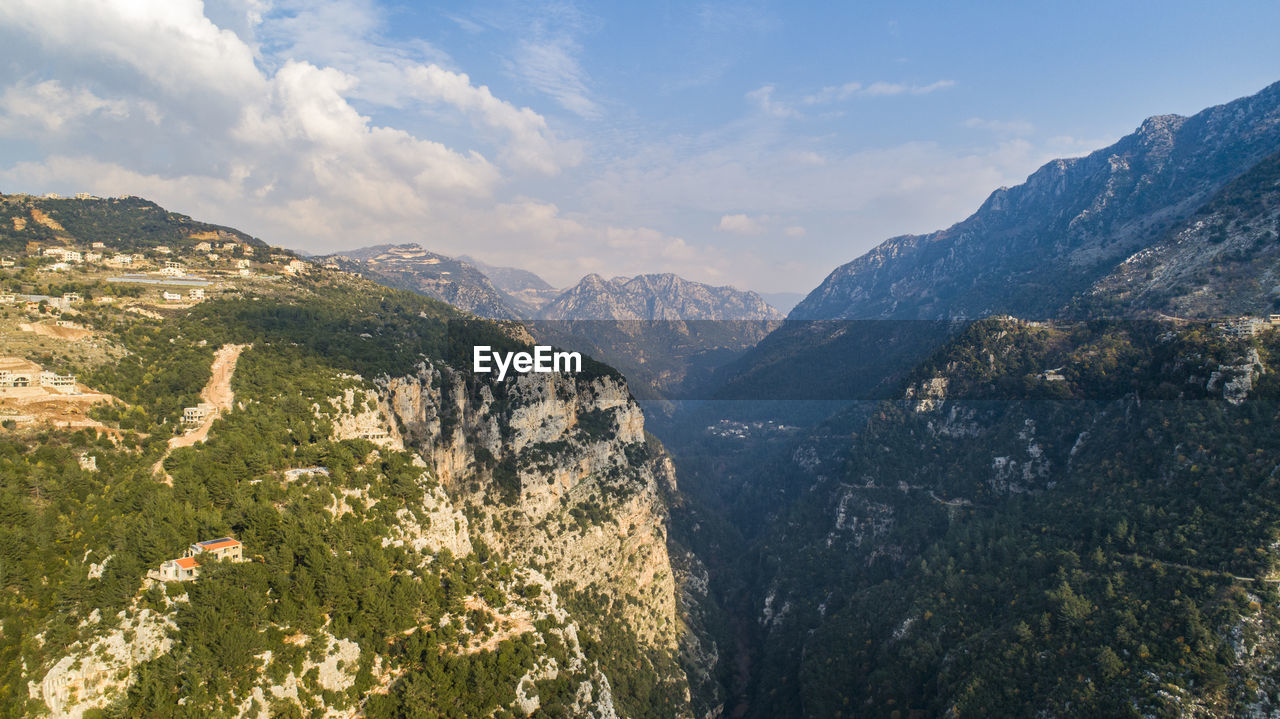 Scenic view of mountains against sky. aerial shot of the green valley and river 