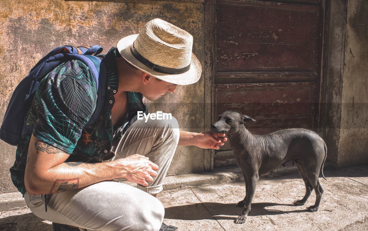 Young man touching dog