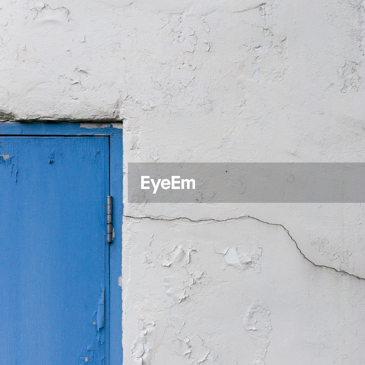 Close-up of white wall and blue door