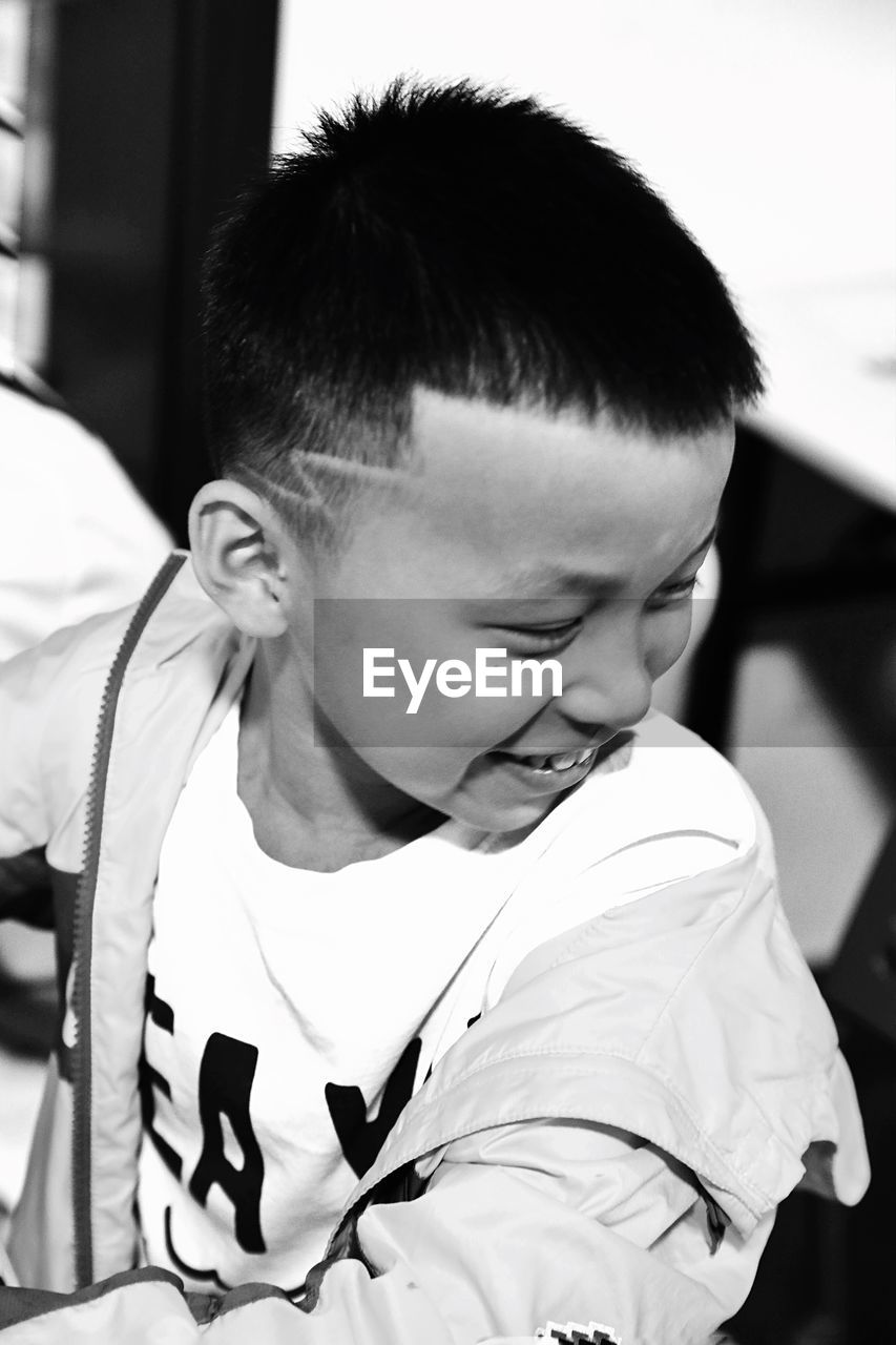 Close-up of boy smiling while sitting in classroom