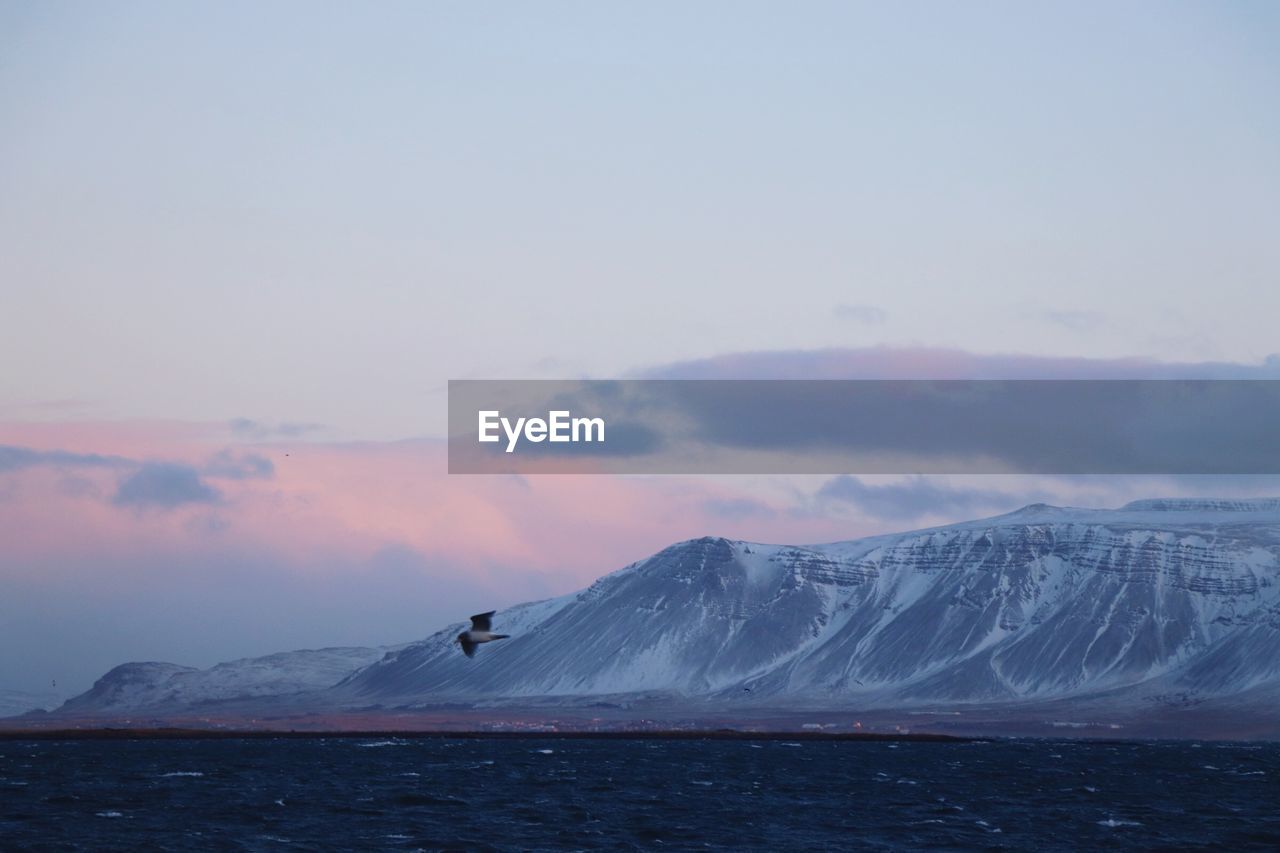 Scenic view of sea against sky during winter