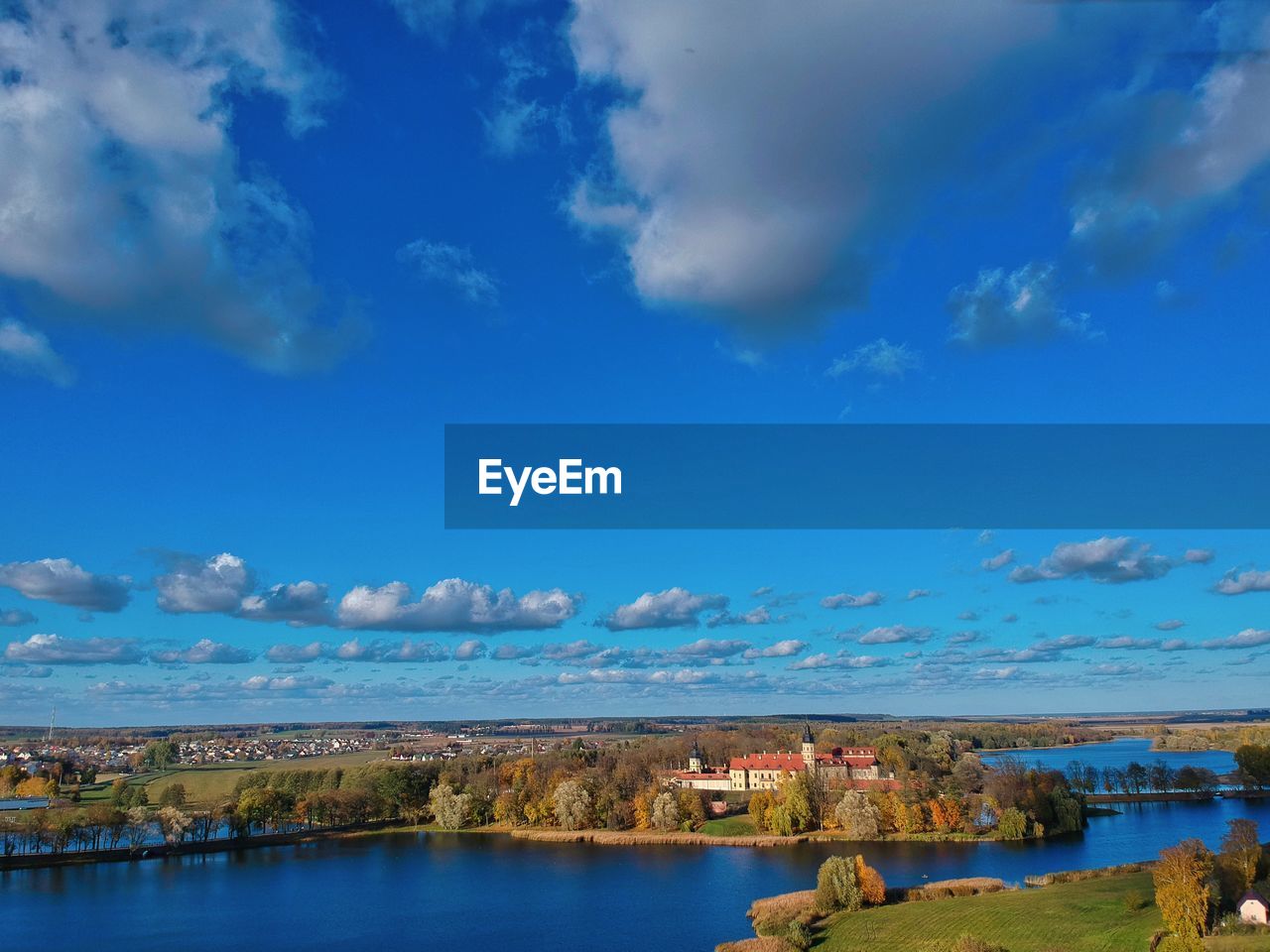 SCENIC VIEW OF LAKE BY BUILDINGS AGAINST SKY