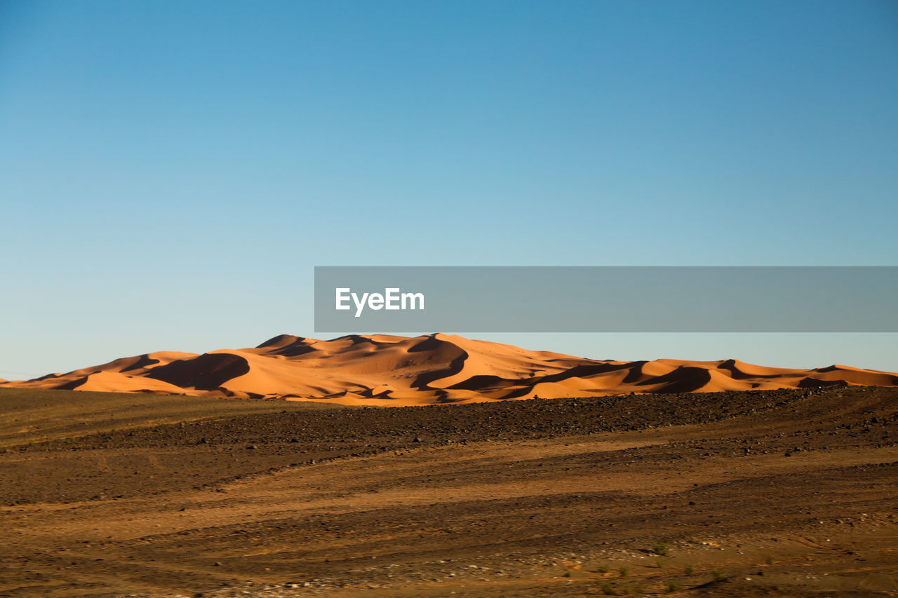 Scenic view of desert against clear sky