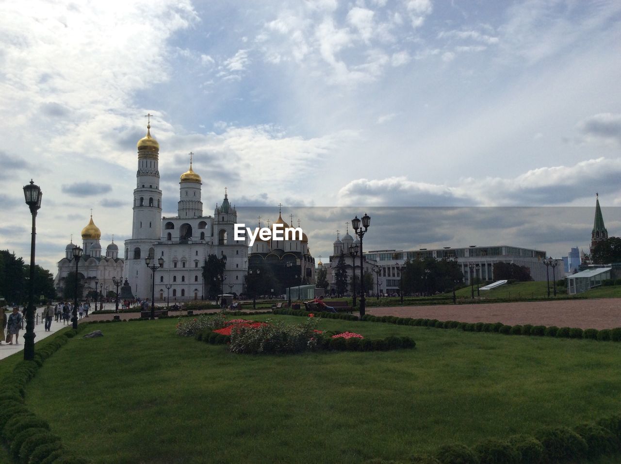 Garden by dormition cathedral against sky