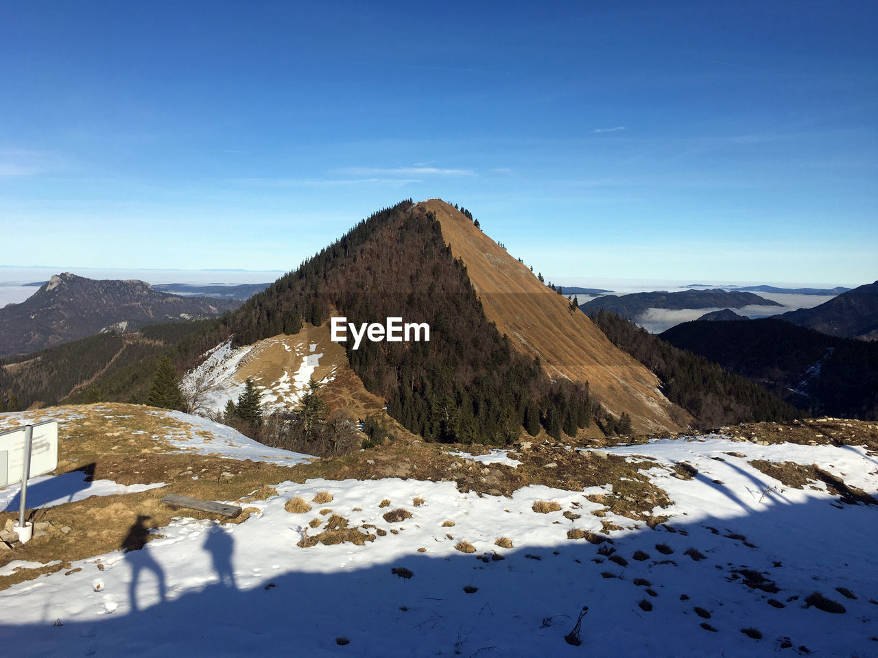 SNOW COVERED MOUNTAINS AGAINST BLUE SKY