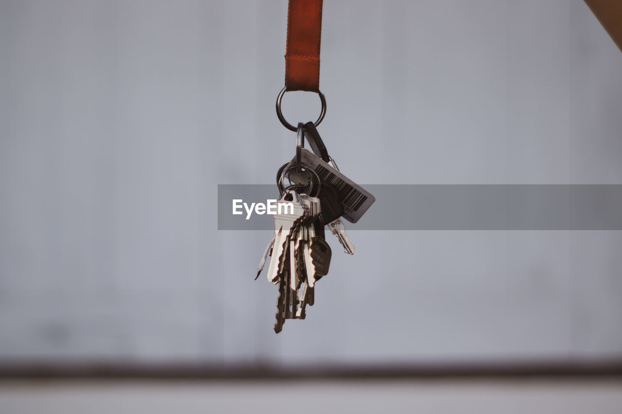 Close-up of key hanging against wall
