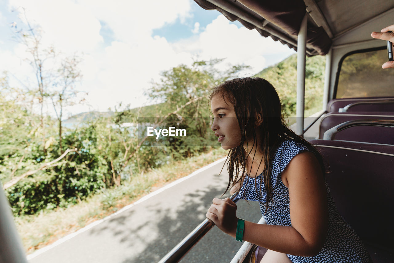 Girl in open air taxi touring usvi in popular cruise port destination