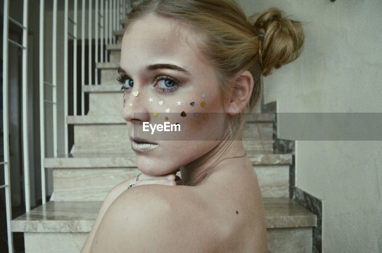 Portrait of young woman with glitter make-up