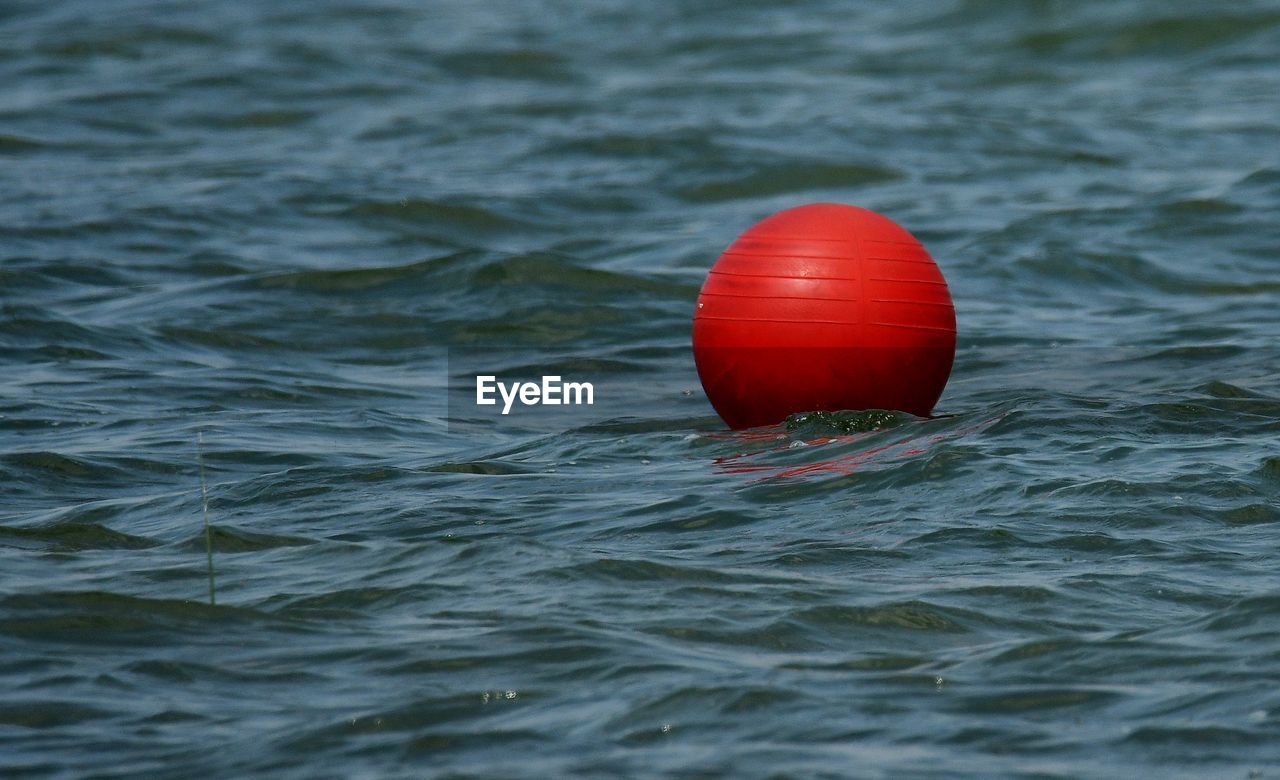 Red ball bouy in reservoir