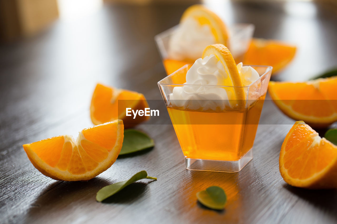 CLOSE-UP OF ORANGE SLICE ON TABLE