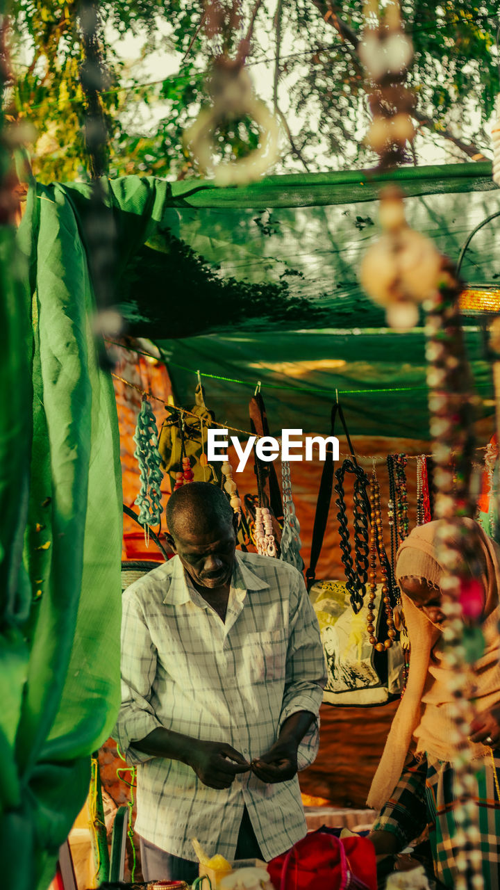 A brown skin man in a bracelets store