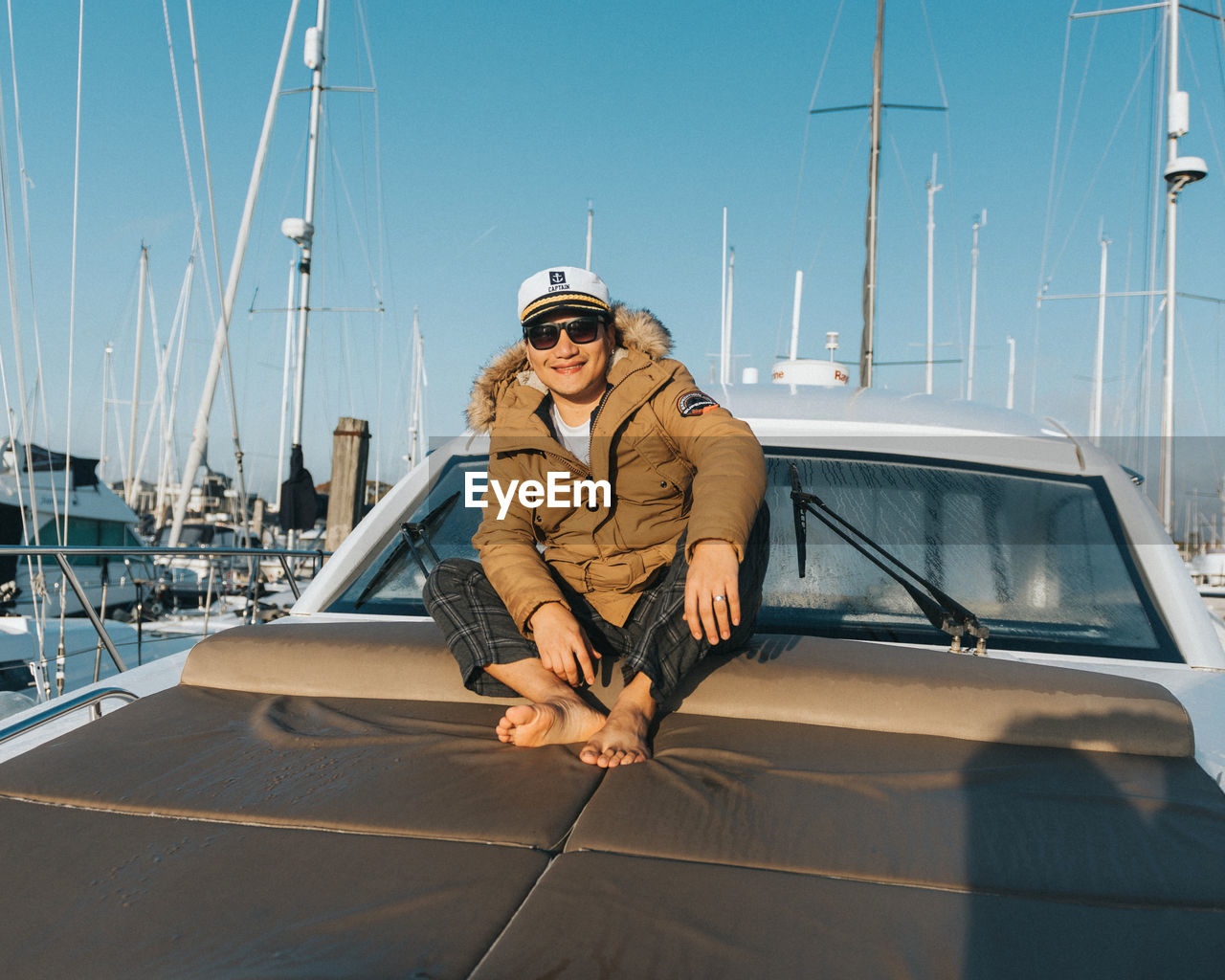 Low angle view of man sitting on the yacht