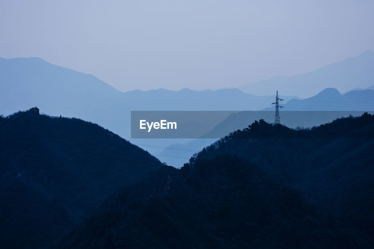 Scenic view of silhouette mountains against sky