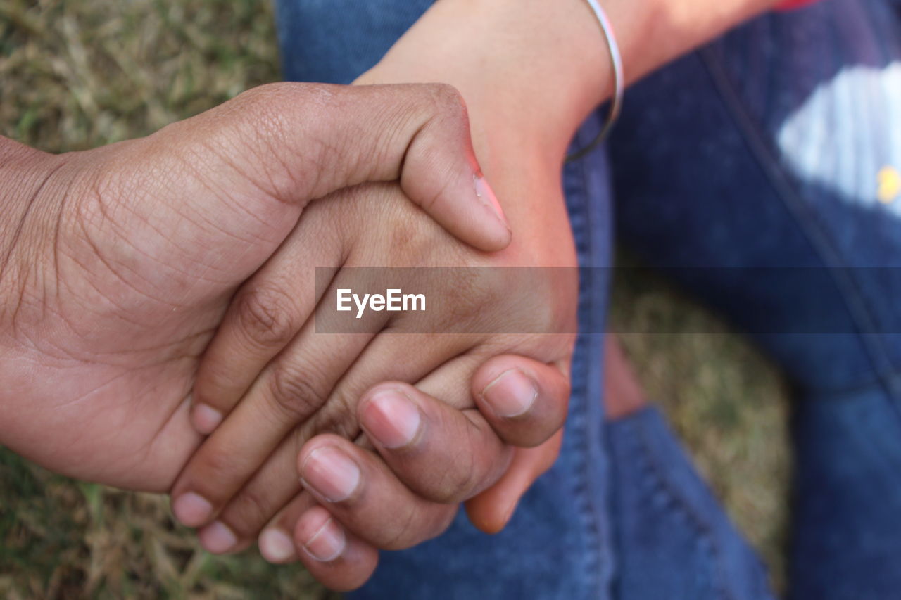 Couple holding hands outdoors