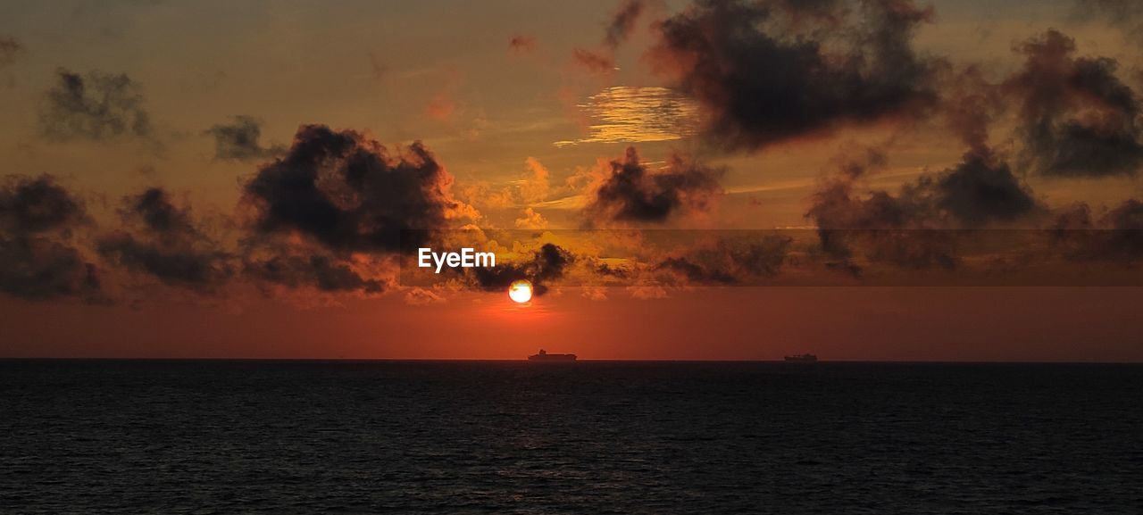 SCENIC VIEW OF SEA DURING SUNSET