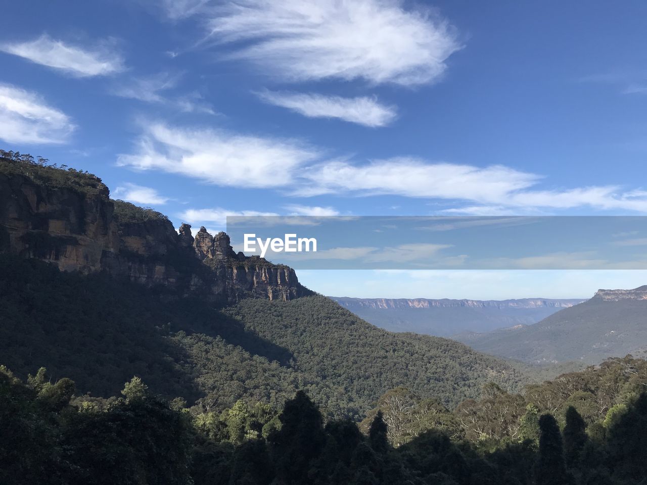 Scenic view of blue  mountains against sky