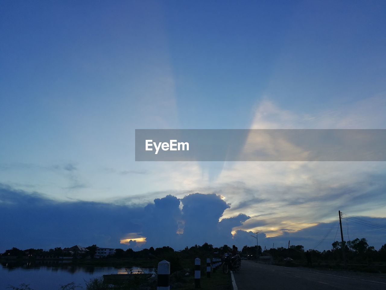 SCENIC VIEW OF BLUE SKY AND TREES AGAINST SUNSET