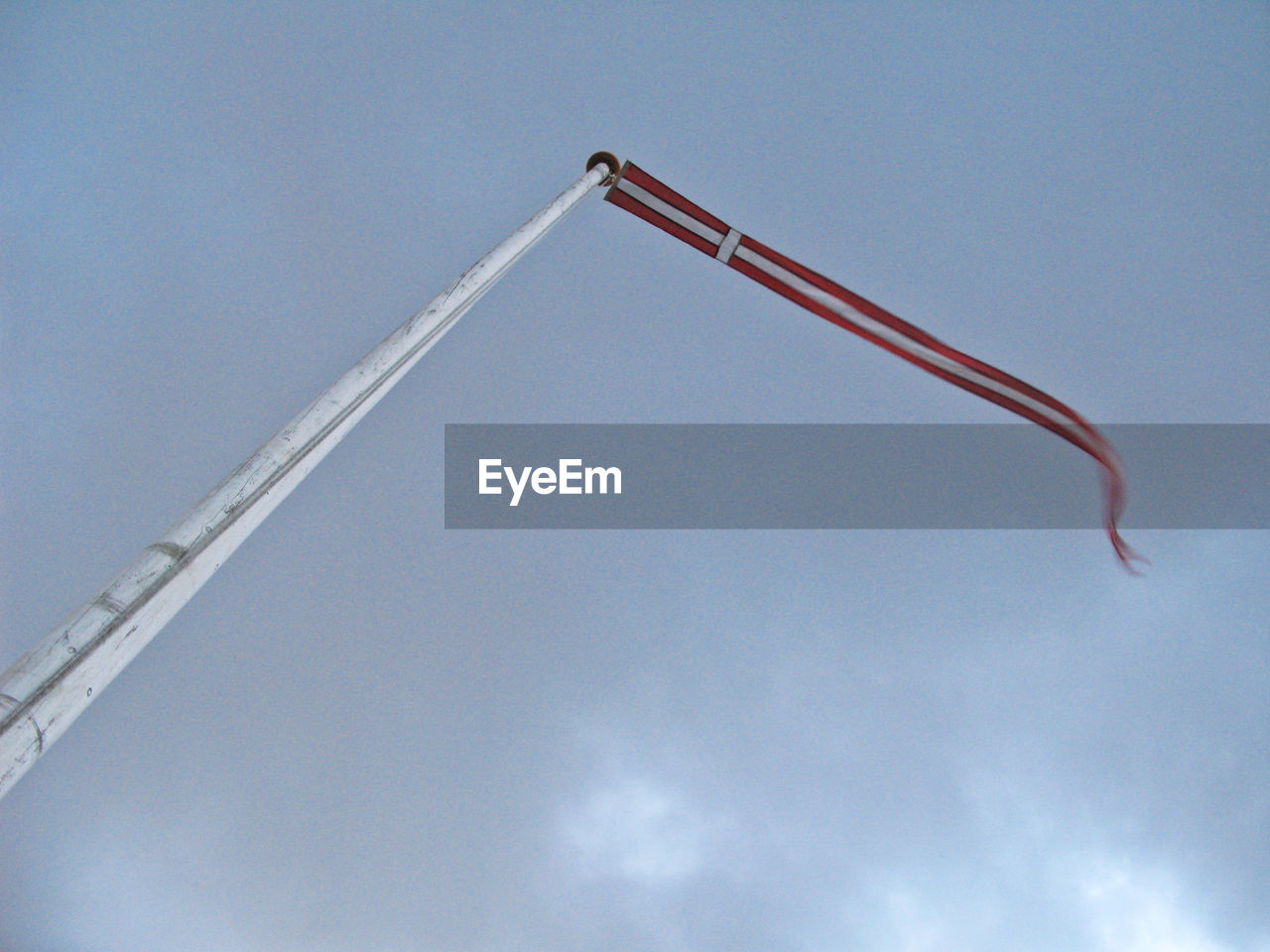LOW ANGLE VIEW OF CRANE FLYING AGAINST SKY