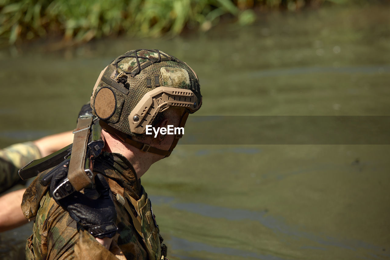 close-up of army soldiers standing in lake