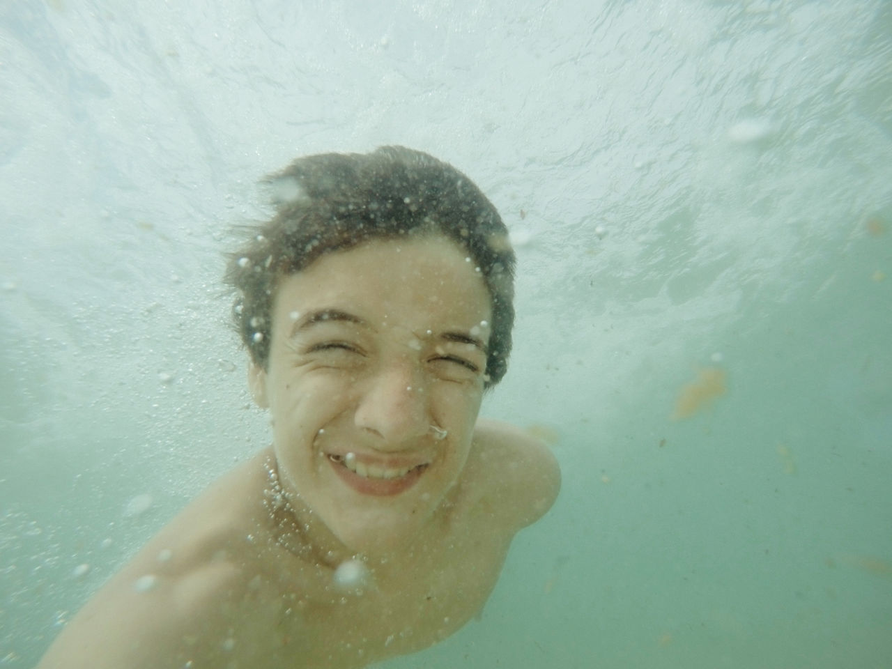 Teenage boy swimming underwater