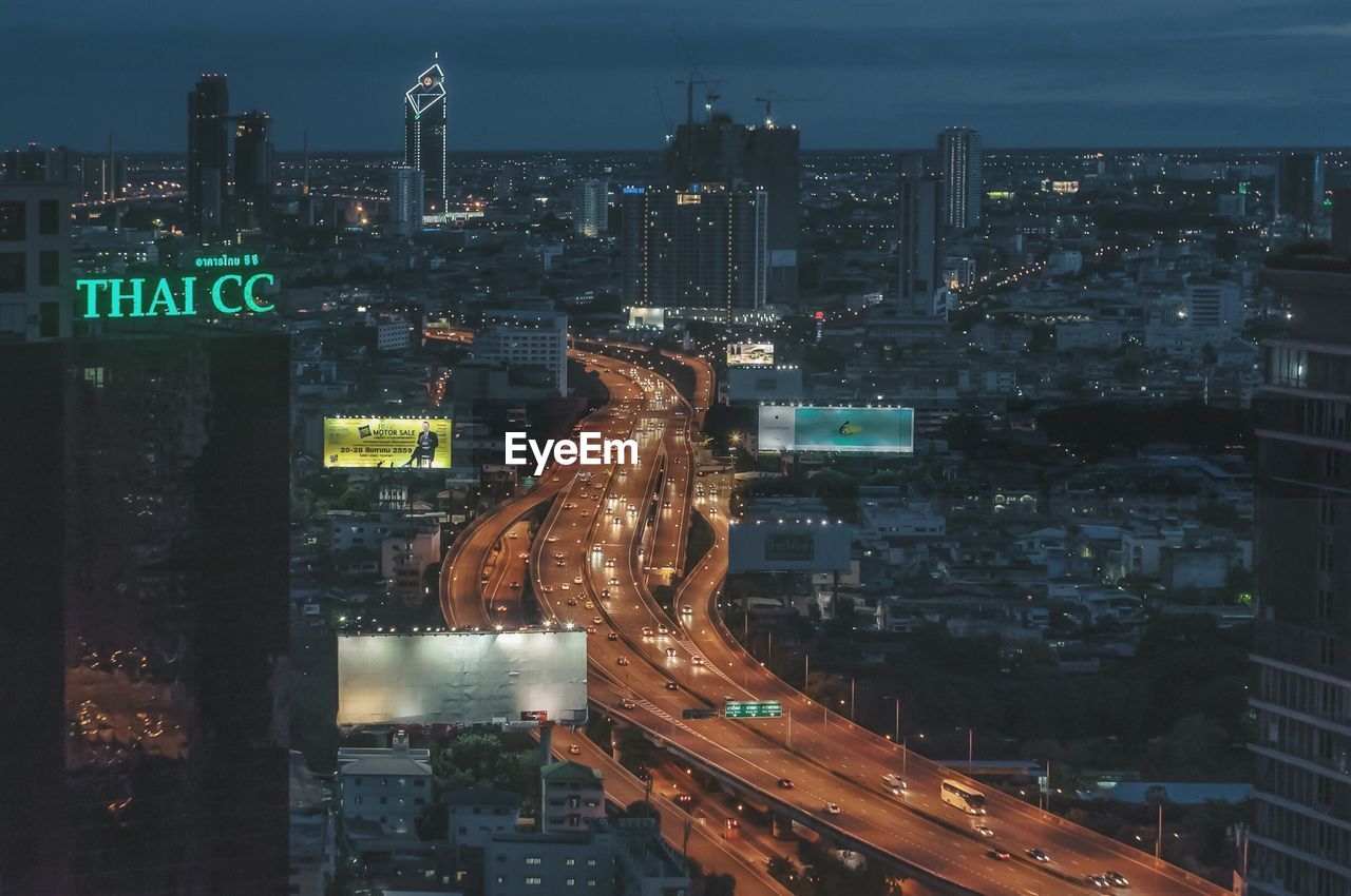 HIGH ANGLE VIEW OF ILLUMINATED CITYSCAPE