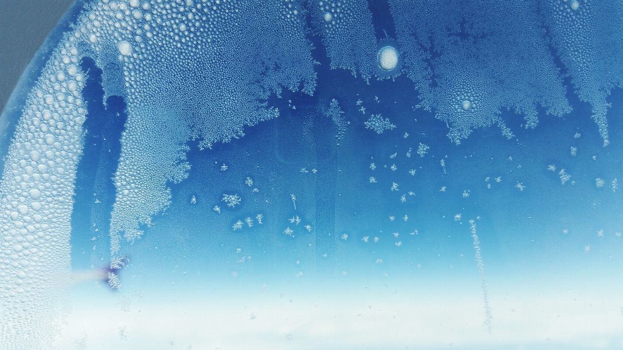 Close-up of ice crystal on airplane window