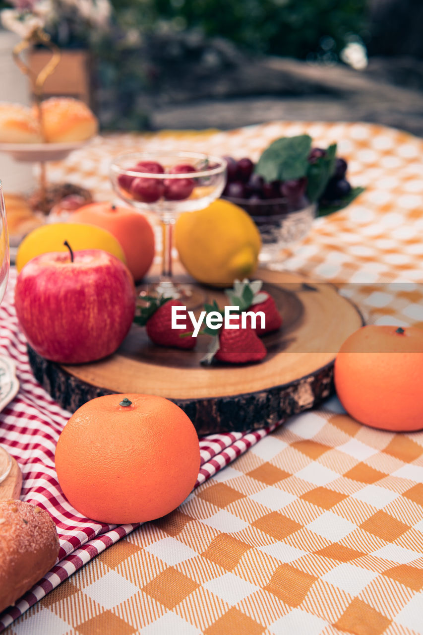 CLOSE-UP OF ORANGE FRUIT ON TABLE