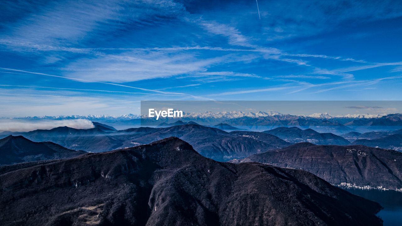 Scenic view of snowcapped mountains against blue sky