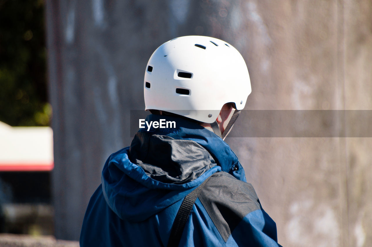 Man wearing cycling helmet on sunny day