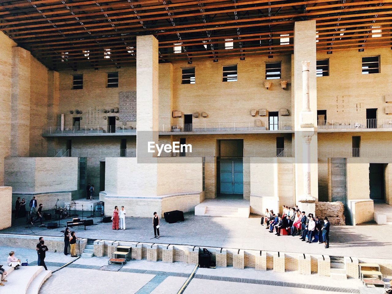 GROUP OF PEOPLE WALKING IN HISTORICAL BUILDING