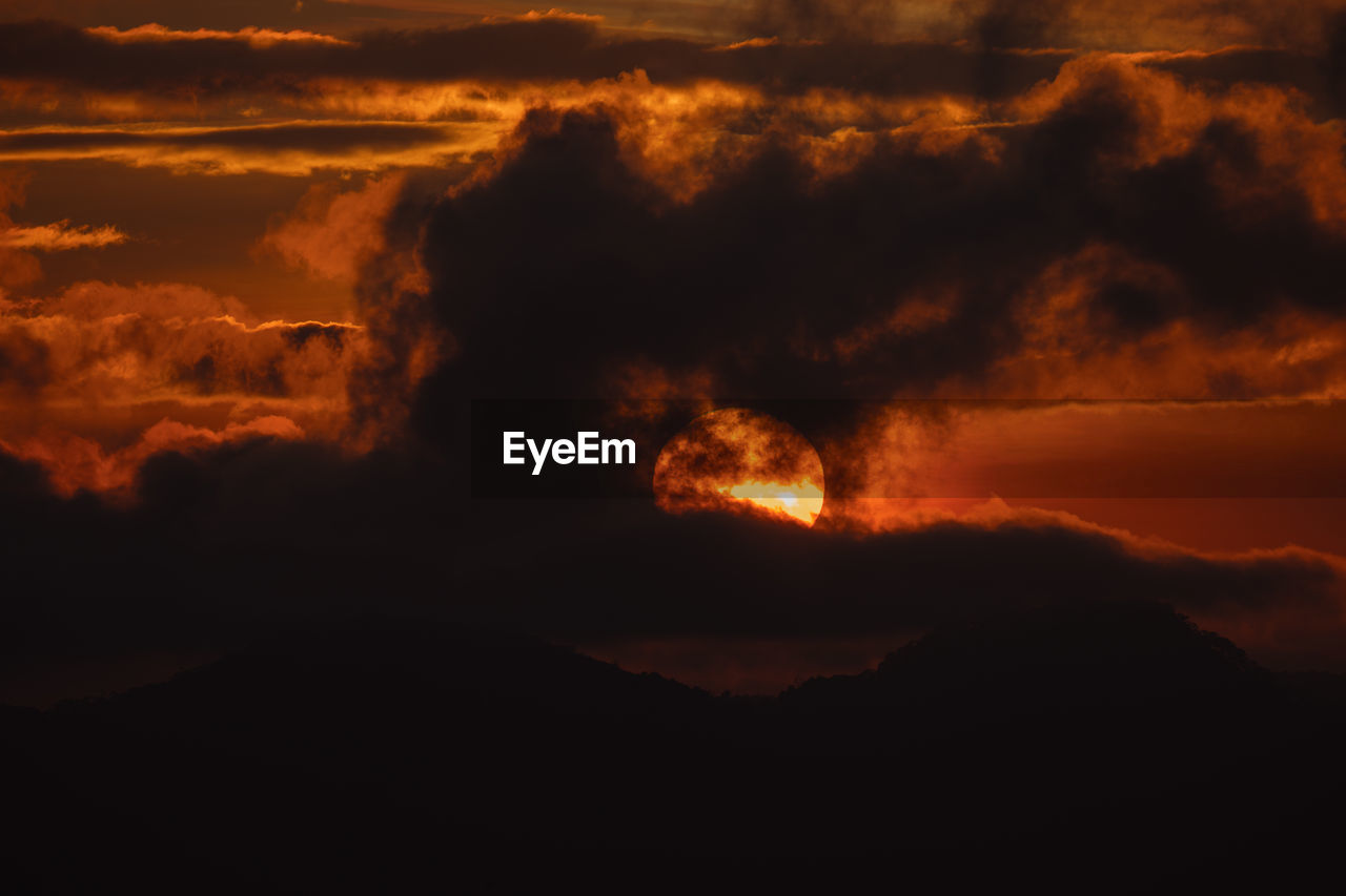 sunset, beauty in nature, cloud, sky, nature, dawn, mountain, no people, environment, orange color, geology, lava, afterglow, scenics - nature, land, power in nature, heat, warning sign, night, volcano, outdoors, landscape, horizon, evening, burning, red sky at morning, sign, erupting, fire, non-urban scene