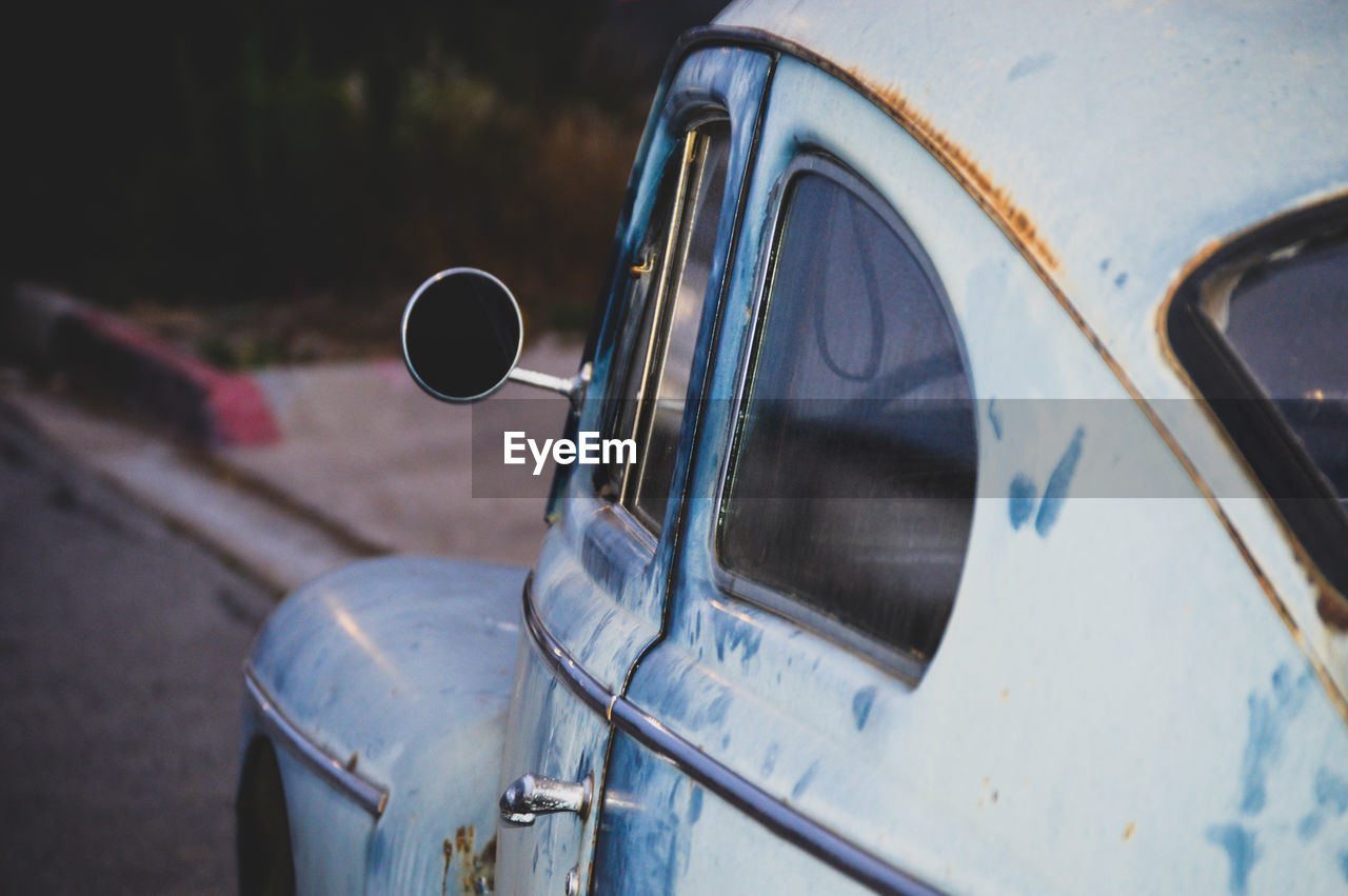 Close-up of vintage car on road