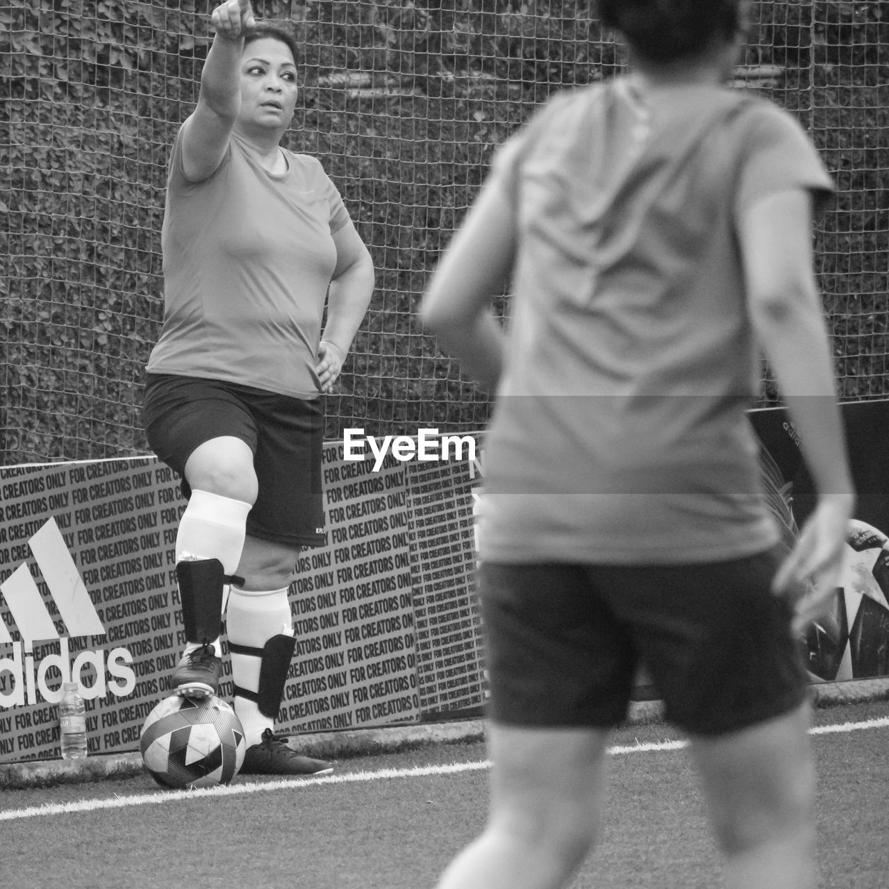 sports, black and white, two people, athlete, monochrome, motion, men, sports clothing, adult, monochrome photography, black, competition, lifestyles, white, young adult, player, exercising, clothing, ball, togetherness, leisure activity, day, running, sports equipment, full length, women, activity, competitive sport, friendship, person, architecture