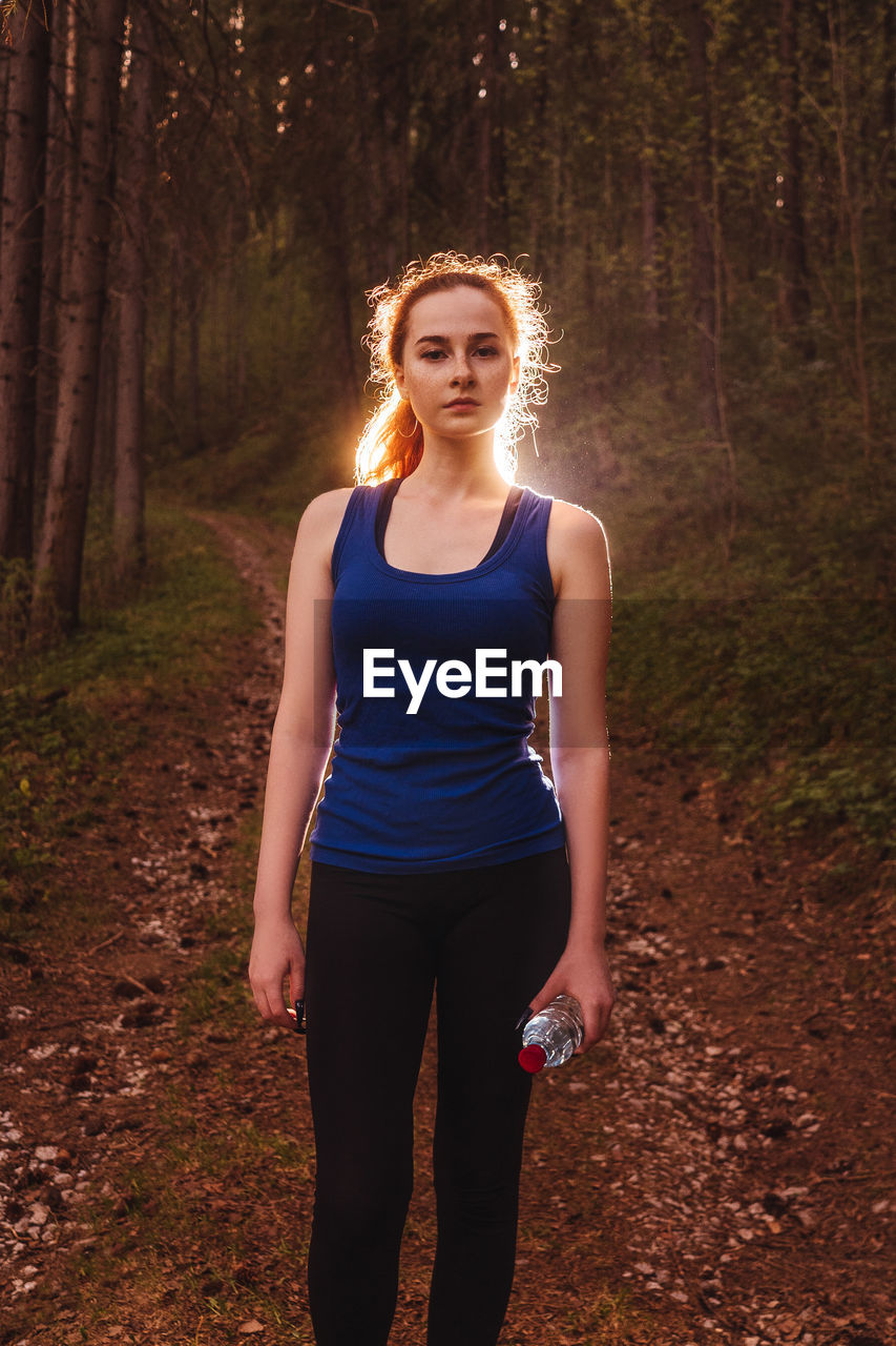 portrait of woman standing in forest