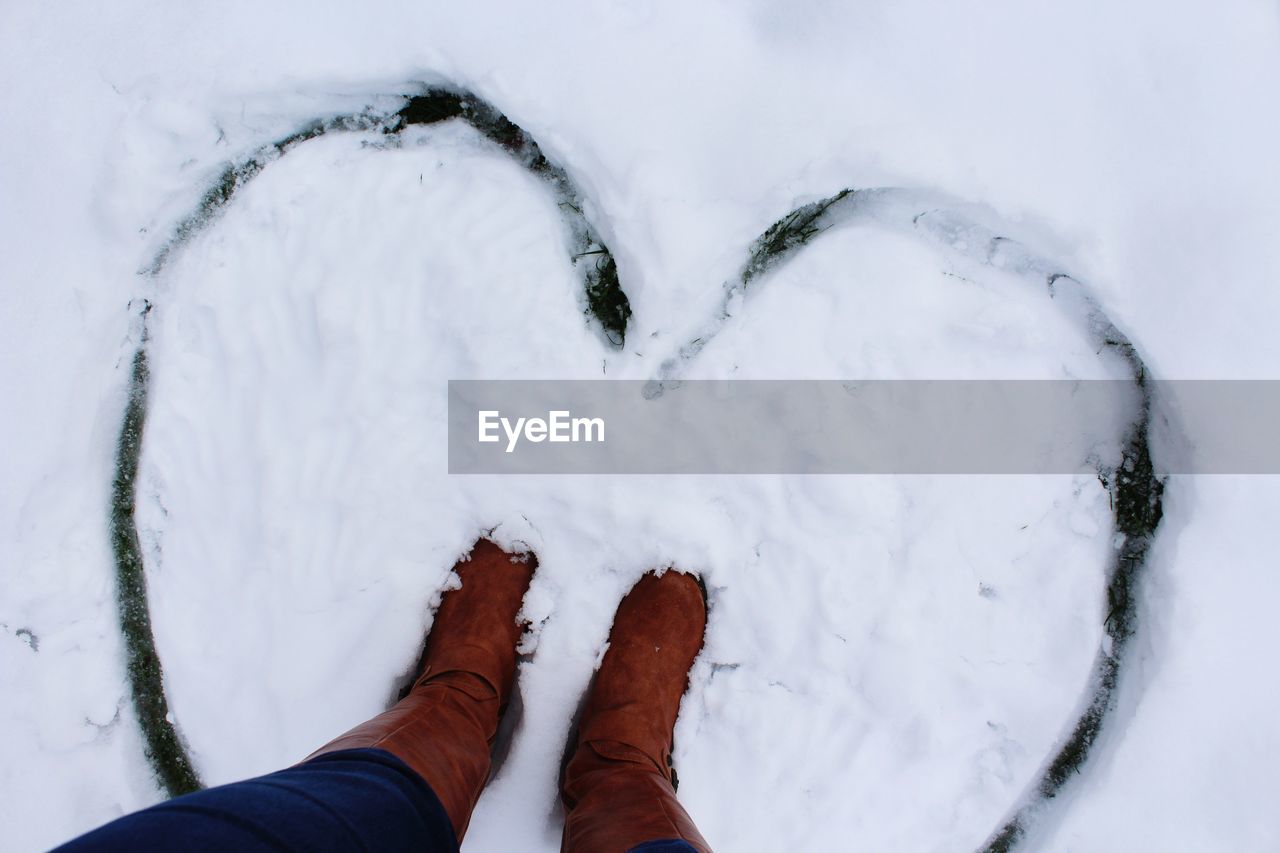 LOW SECTION OF PERSON ON SNOWCAPPED MOUNTAIN