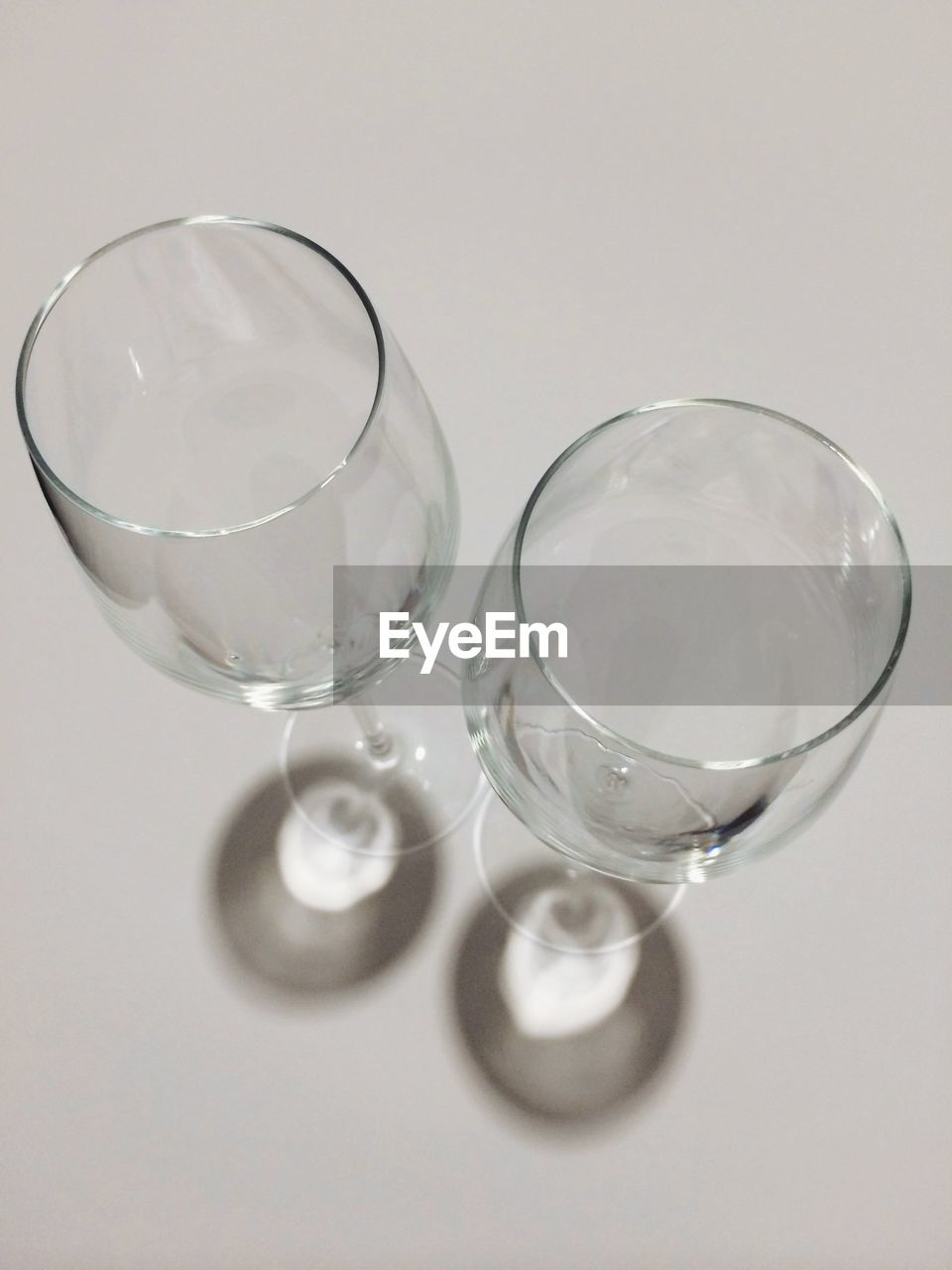 High angle view of empty wineglasses over gray background