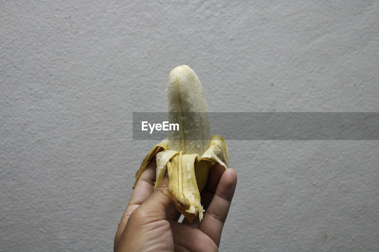 Peeled banana on a hand