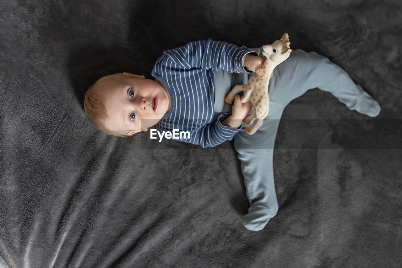 Directly above shot of baby lying on bed at home