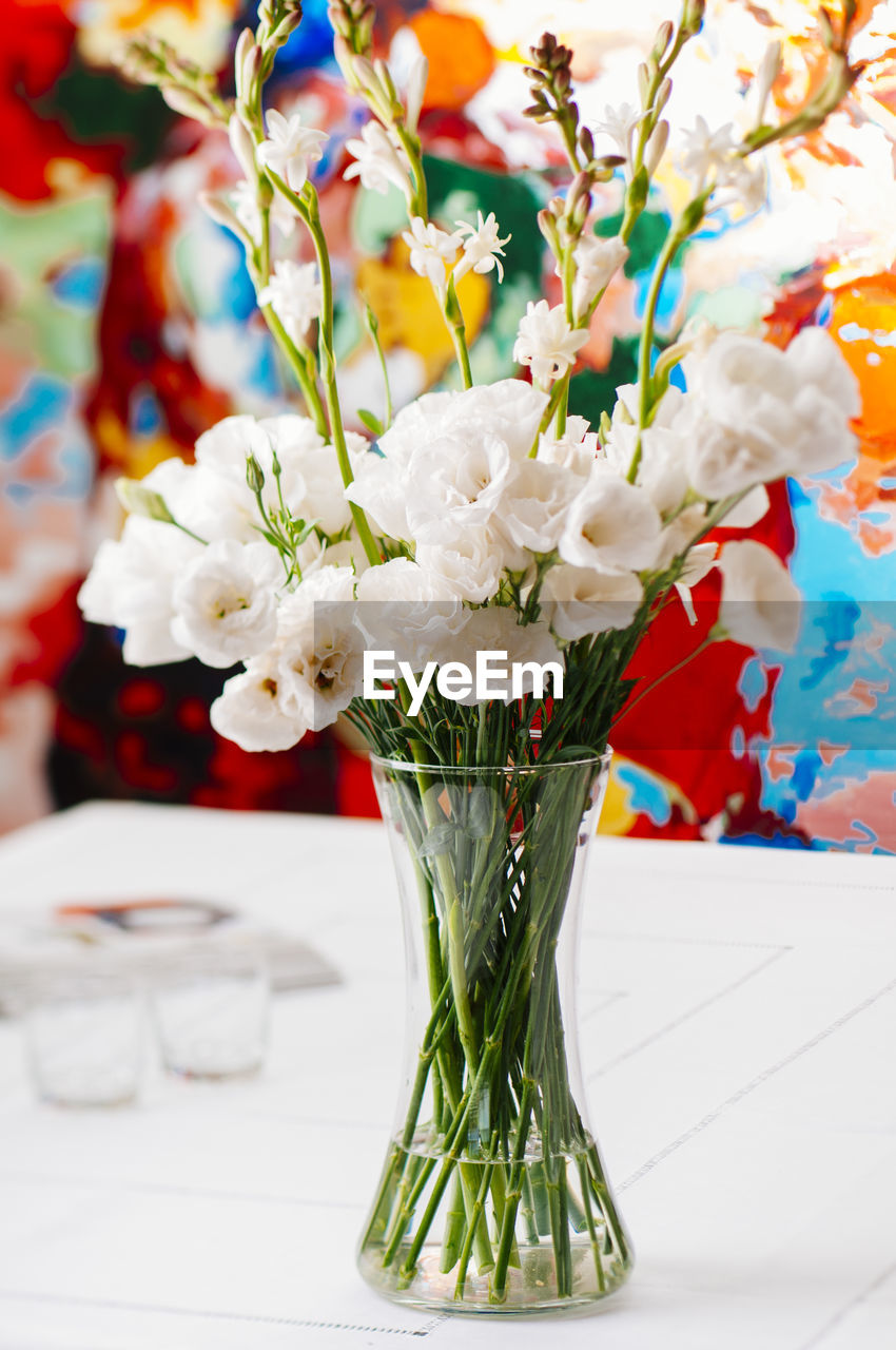 Close-up of white flowers in vase on table