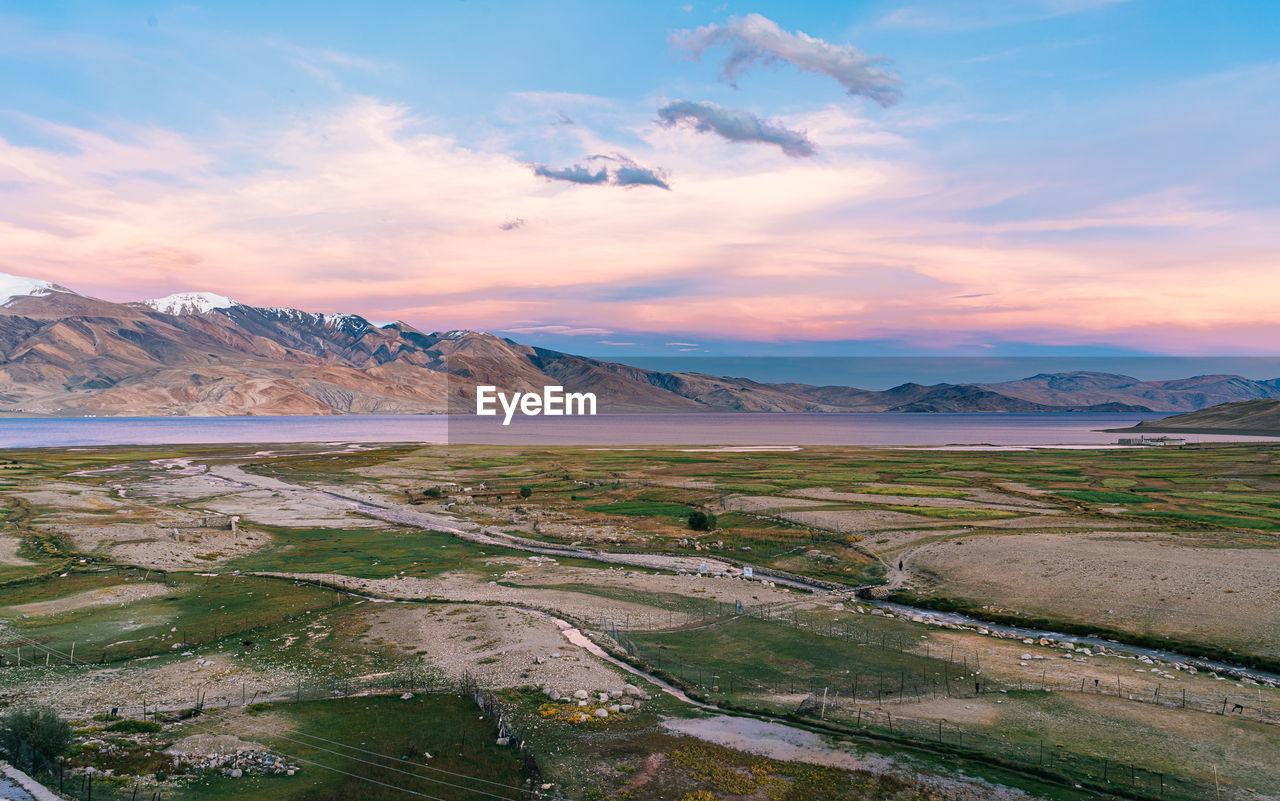 Scenic view of landscape against sky during sunset