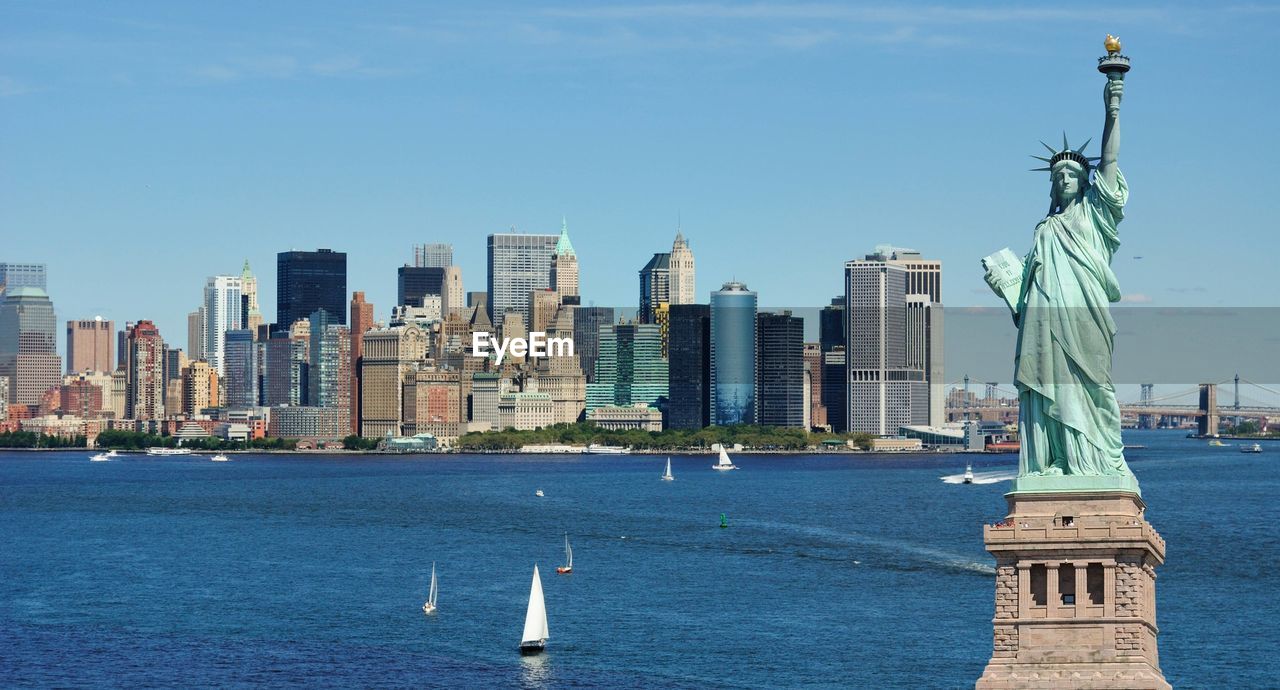 Statue of liberty with cityscape in background