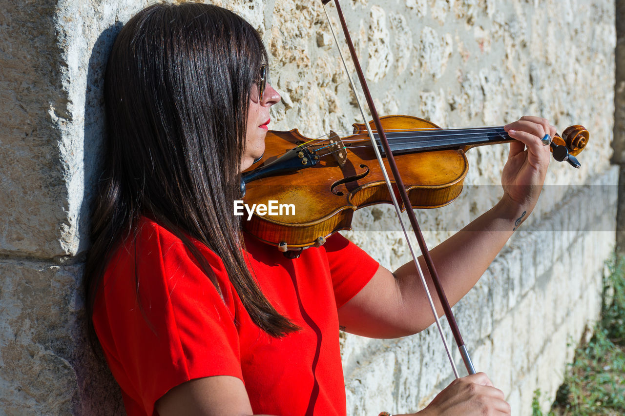 Close-up of woman playing violin