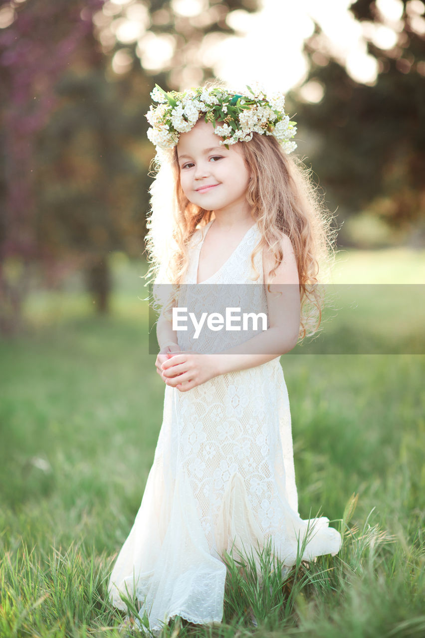 Portrait of girl wearing wreath at park