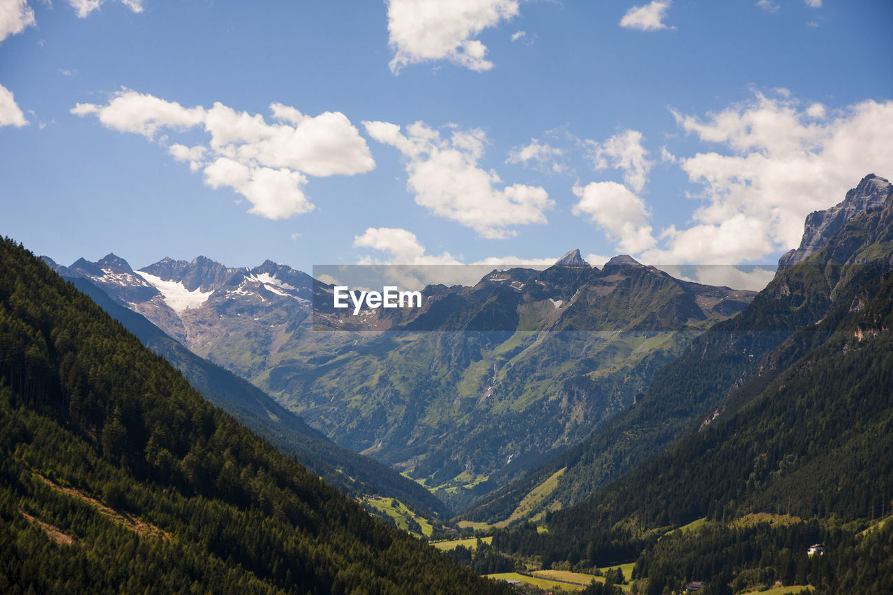 Scenic view of mountains against cloudy sky