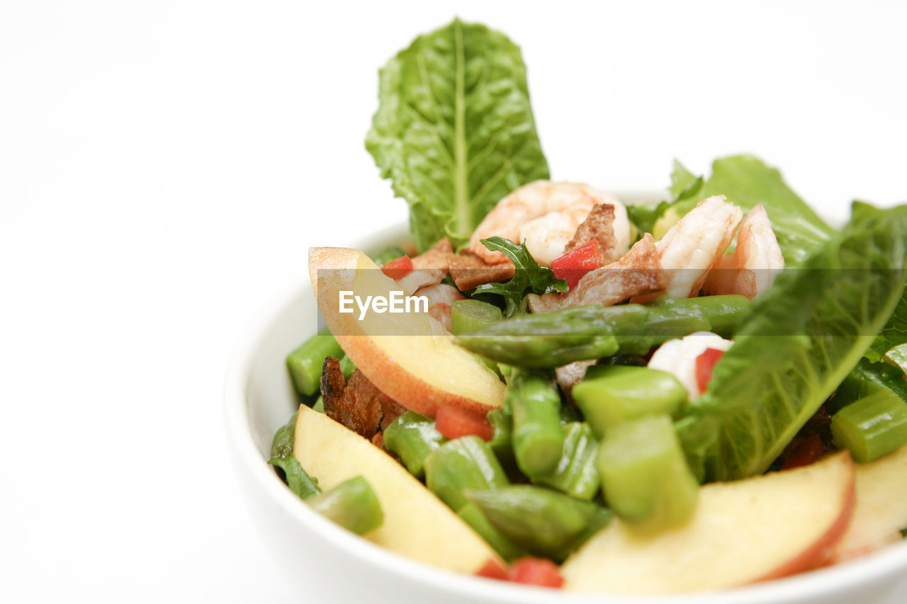 close-up of vegetables in bowl against white background